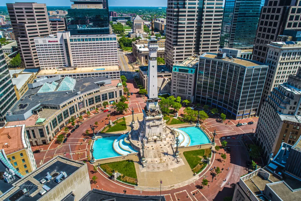 Aerial view of Monument Circle with tall statue on post in middle of traffic circle area in Indianapolis, Indiana